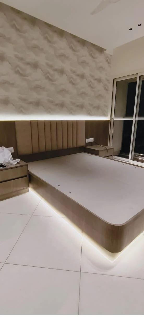 Floating platform bed with concealed perimeter LED illumination and custom vertical fluted headboard