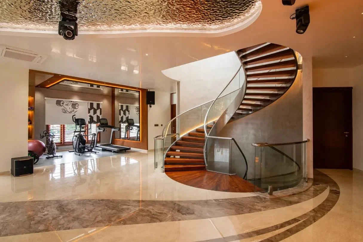 Sculptural spiral wooden staircase with curved glass balustrade and Italian marble flooring